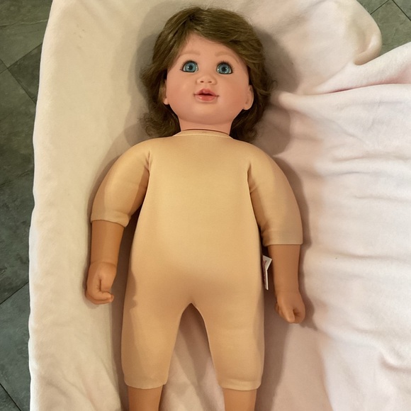 Adorable Baby Doll with Blue Eyes and Pink Outfit - Picture 4 of 7